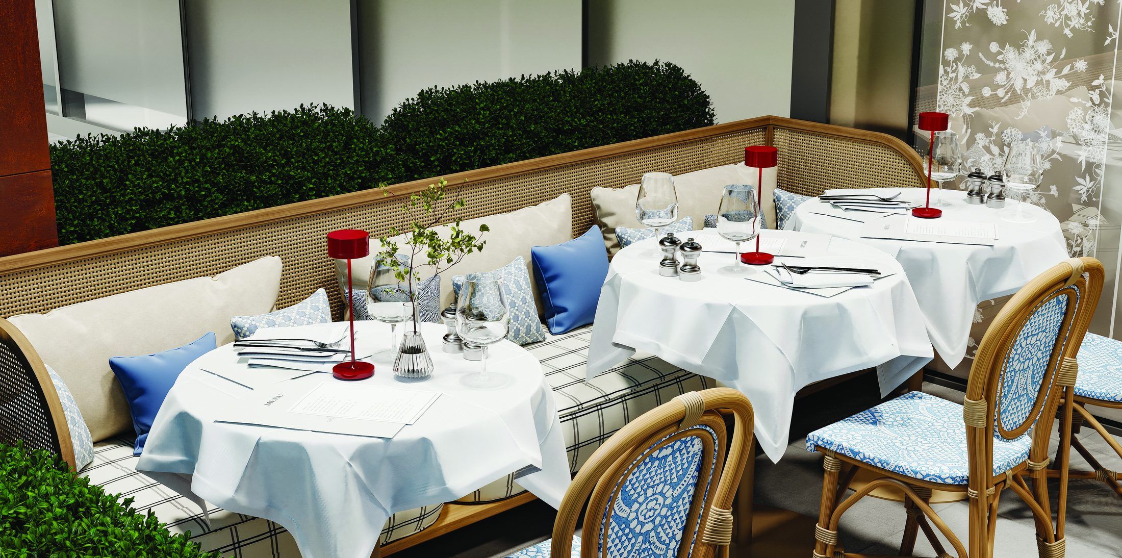 Terrace tables with blue rattan chairs and red lamps